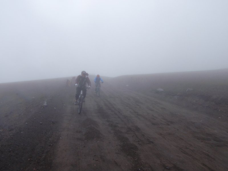 Merida and Ann biking down a Volcano near the equator in freezing cold sleet.